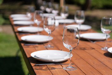 Served wooden table without a tablecloth. Cafe in the open air park