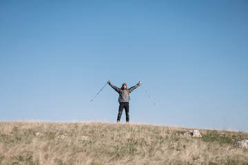 Traveler man spreading hands over the hill