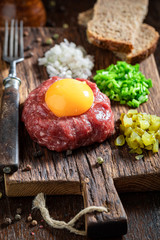 Spicy beef tartare with chives, gherkin and yolk