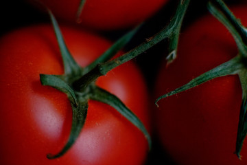 Tomatoes red, ripe, juicy fruit directly off of the vine