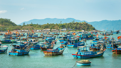 Fototapeta na wymiar A small town of fishermen, located near the city of Nha Trang, Vietnam. The accumulation of fishing boats in the bay, preparing to sail in the sea for fishing.