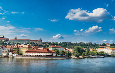 Fototapeta na wymiar Scenic summer panoramic view from Charles Bridge to beautiful Prague quay, old Town pier and Vltava river, Czech Republic