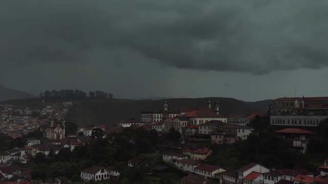 Motion time lapse of dark clouds rolling over the historical colonial mining city of Our Preto in Brazil causing heavy rainfall following a clearance and smaller showers