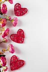 Flowers and red hearts on a white background for Valentine's Day