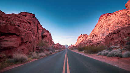A road through mountain valley at sunrise. Valley of Fire, Nevada