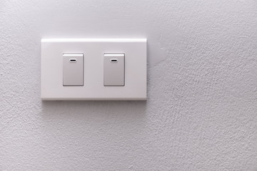Electricity switch or lamp switch on white wall
