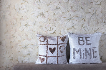 Pillows with sequins. Two white pillows swith paillettes. First pillow with a tic-tac-toe, second...