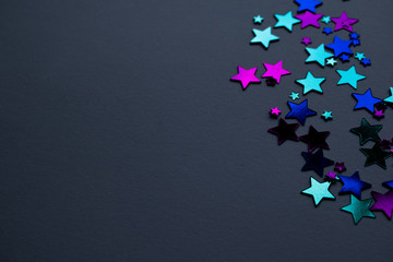 Bright stars on grey background, pink, blue and teal
