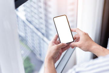 Mockup image blank white screen cell phone.man hand holding texting using mobile.background empty space for advertise text.people contact marketing business,technology 