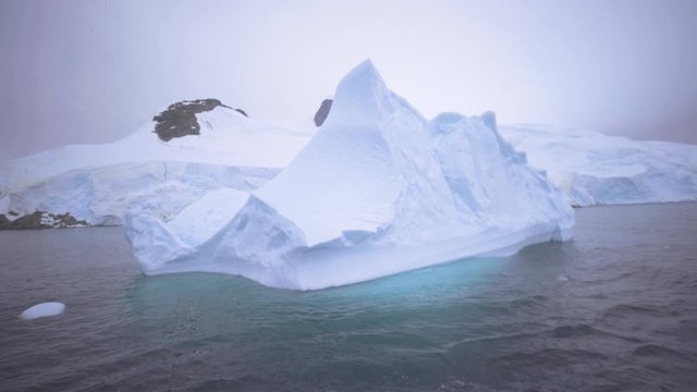 Blue Iceberg Floating In Lemaire Channel, the strait of Antarctica booth island