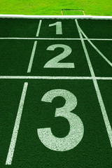 White lines of stadium and texture of running racetrack green rubber racetracks