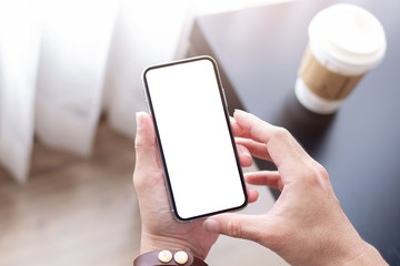 Mockup image blank white screen cell phone.man hand holding texting using mobile.background empty space for advertise text.people contact marketing business,technology 