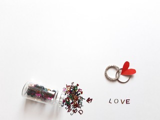 love alphabets, rings and red heart on white background