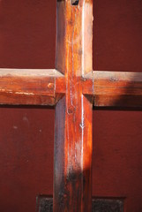 Wood cross on red background