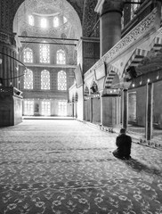 Man praying in a mosque in Turkey, in Black and white