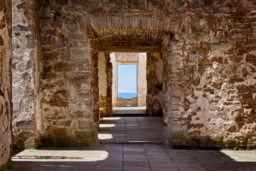 Walkway through old doorways at Borgholm castle, a well preserved ancient castle ruins at the swedish island Oland.