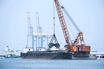 Fototapeta premium Sand tanker at the sand loading station with loader