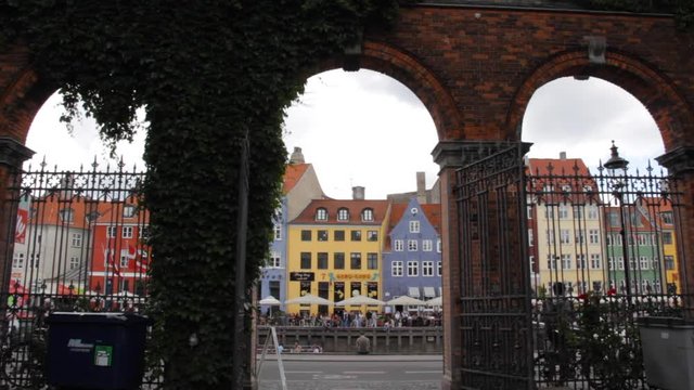Beautiful Nyhavn Framed With Brick Arches (Copenhagen, Denmark) - Cyclist Rides By in the Background
