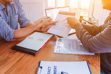 The lawyer is currently consulting on legal contract documents to be used as a contract between...