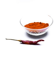 Indian red chilli with powder in a bowl isolated on white background