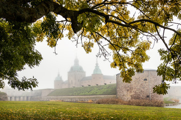 Autumn view of Kalmar castle surrounded by heavy mysterious fog. © tomalv