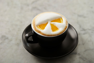 Cafe latte, latte art with orange 