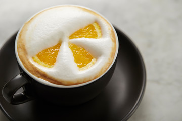 Cafe latte, latte art with orange 