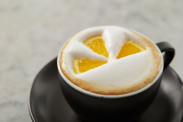 Cafe latte, latte art with orange 