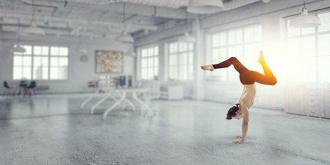 Fototapeta na wymiar Dancer guy doing onehand stand. Mixed media