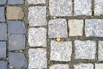 Texture of old Cobbled Pavement close-up. Granite Stone Background..