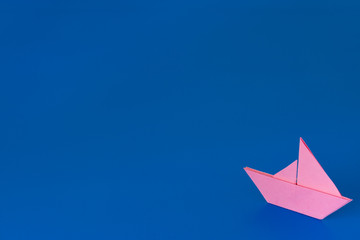 Origami Boat against blue background