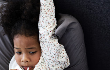 Beautiful African american girl kid smile portrait and drinking milk on bed.