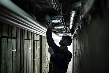Male Electrician Installing Light
