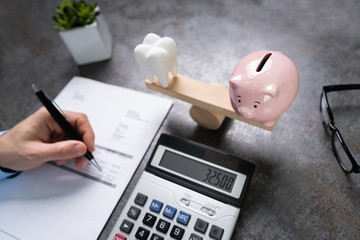 Tooth And Piggy Bank On Seesaw