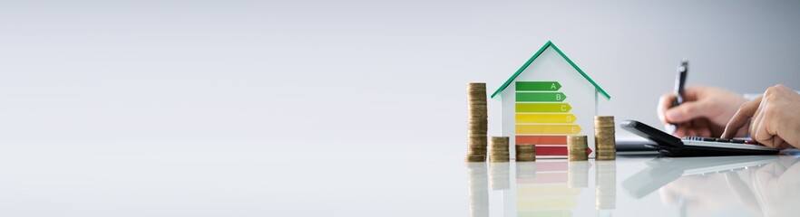 Man Calculating Energy Efficient House