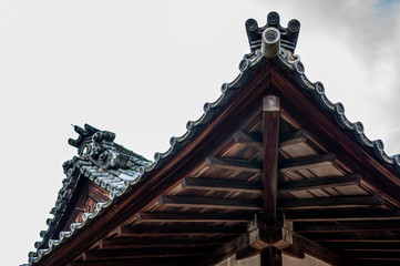 Roof of a Japanese Buddhist temple on cloudy background