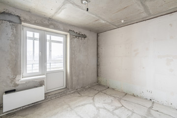 Empty interior for design, gray concrete wall. Empty room. Space for text and picture. Concrete walls, slabs, interior of a new residential building. Partitions in a new apartment.