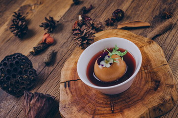 Homemade dessert, a traditional Chinese snack stewed in sugar water with snow pear, in a white bowl.