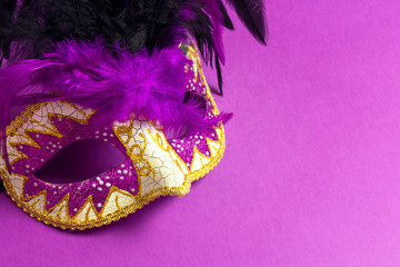 Carnivale mask on a purple background.