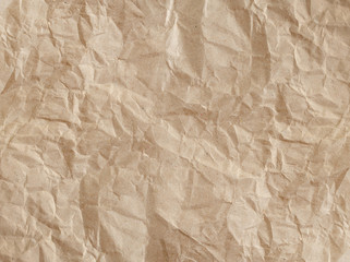 Textured crumpled beige paper craft background.