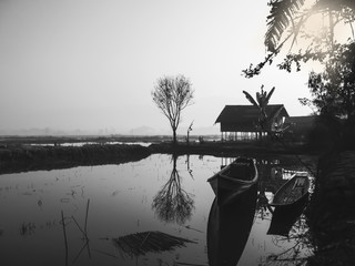 Beautiful landscape of a wooden house near by Inle Lake in Myanmar in black and white colors. 