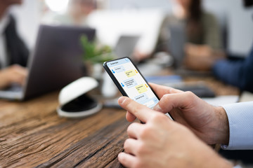 Distracted Businessman In Meeting