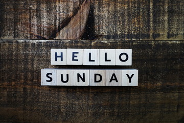 Hello Sunday alphabet letter with space copy on wooden background