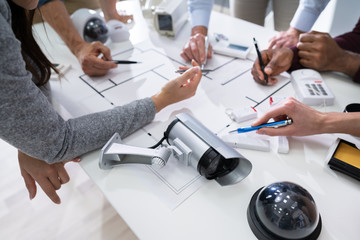 Group Of Security Engineers Working On Blueprint
