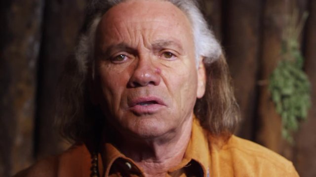 Native American Medicine Man in Prayer Meditation in Hogan