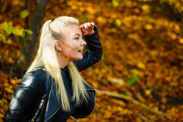 Blonde woman relaxing in autumn park