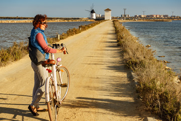 Woman with bike at San Pedro del Pinatar park, Spain