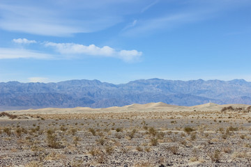 Fototapeta na wymiar desert landscape with mountains and blue sky in Death Valley, California