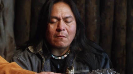 Native American Man in Prayer Meditation with Sage Smoke in Hogan