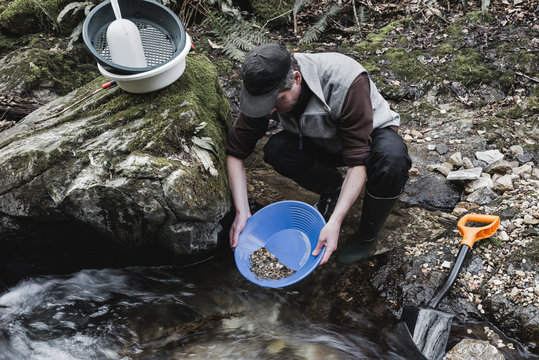 Outdoor adventures on river. Gold panning, moody look